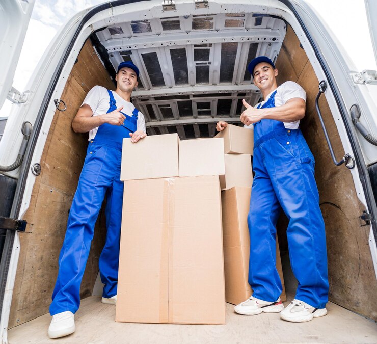 two-removal-company-workers-unloading-boxes-from-minibus_179755-17341